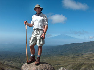 Tom on Kilimanjaro (Mount Meru in the background)